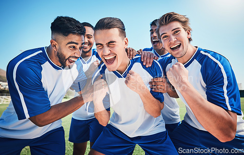 Image of Football player, game and men celebrate together on a field for sports and fitness win. Happy male soccer team or athlete group with fist for challenge, competition or achievement outdoor on pitch