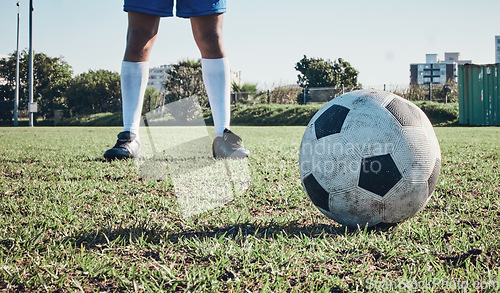 Image of Sports, soccer ball and feet or shoes of person to kick on field, fitness training or ready for a goal on grass. Football, sneakers and athlete in exercise, competition or sport challenge for goals