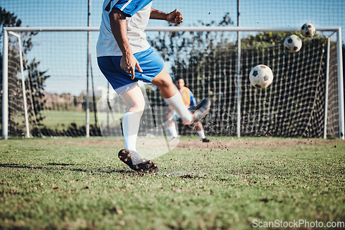 Image of Sports, training and football player score a goal for challenge at a game or match at tournament. Fitness, exercise and back of soccer athlete kicking a ball at practice on outdoor field at stadium.