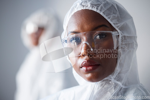 Image of Science, serious and portrait of a black woman in a lab with a suit for security from virus. Face, hospital and an African scientist with glasses and clothes for safety from chemical and biotech