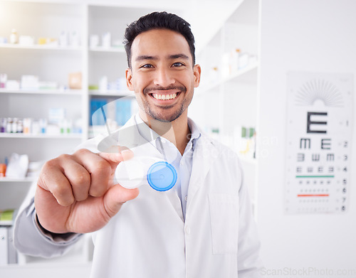 Image of Happy asian man, doctor and contact lenses at pharmacy for sight, vision or healthcare solution at store. Portrait of male person, pharmacist or medical professional smile with eye case at the clinic