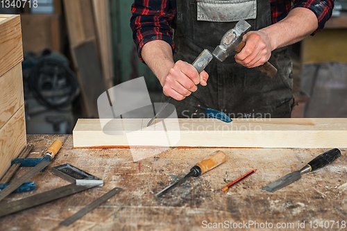 Image of Carpenter working with a chisel