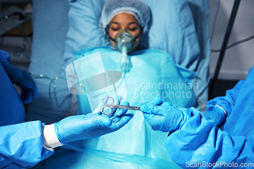 Image of Hands, scissors and surgery with a team of doctors operating on a patient in the hospital emergency room. Medical, equipment or operation with medicine professionals in a clinic theatre from above