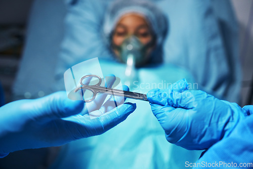 Image of Hands, scissors for operation and a surgeon team with a patient in the hospital emergency room. Medical, equipment or surgery with doctors or medicine professionals in a clinic theatre from above