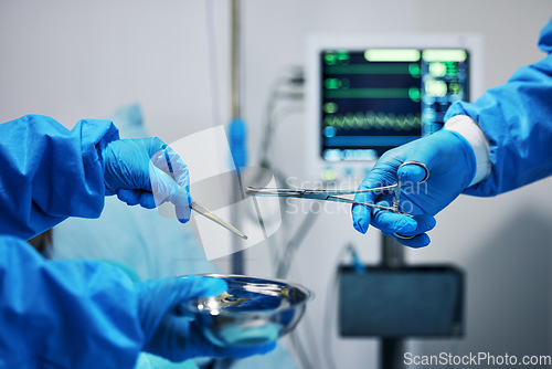 Image of Surgery, scissors in hands and doctor with nurse, health and medical procedure, metal equipment and operating room. Healthcare, people in hospital and surgeon with treatment, tools and closeup