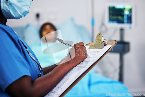 Image of Hands, healthcare and a nurse writing on documents in a hospital during a patient checkup or report. Medical, insurance and information with a black woman medicine professional in a clinic closeup