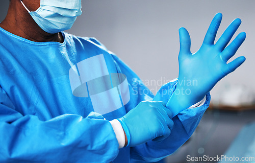 Image of Doctor with gloves, health and surgeon with PPE, safety and protection from bacteria, operating room and closeup. Medical professional, surgery and treatment with person in hospital and healthcare