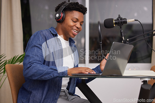 Image of Black man with a podcast, laptop and microphone with headphones for audio, technology or listening to sound in office. Talking, radio and presenter of live streaming show, broadcast or discussion