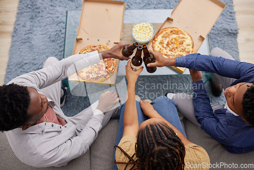Image of Cheers, beer and above of people with pizza, lunch celebration and relax together in a house. Happy, dinner and friends toasting with alcohol and food on the living room sofa to celebrate eating