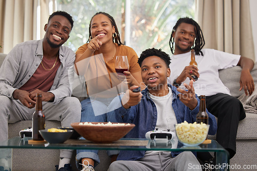 Image of Television, relax and friends on a sofa with beer and popcorn for movie, film or streaming in their home. Group of people, watching tv and smile in living room together with entertainment on weekend