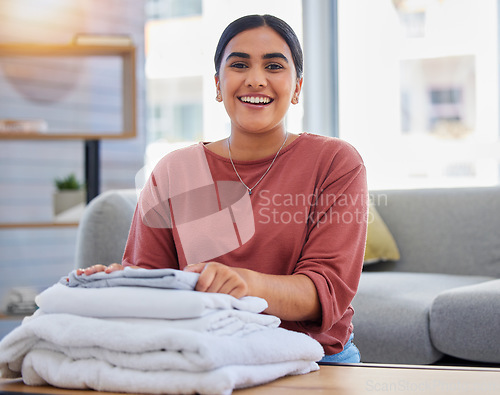 Image of Cleaning, smile and laundry with portrait of woman in living room for housekeeping service, clothes and fabric. Hospitality, happy and cleaner with person at home for maintenance and washing