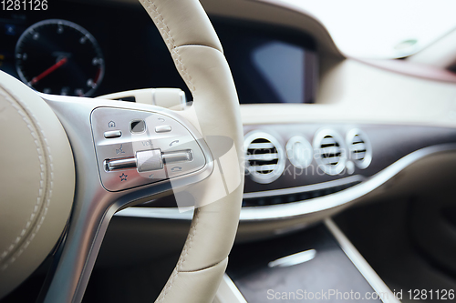 Image of Control buttons on steering wheel. Car interior.