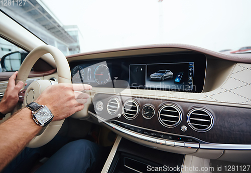 Image of Man sitting and driving in the car.