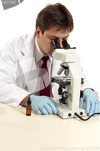 Image of Researcher viewing substance under microscope