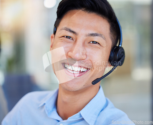 Image of Portrait, smile and an asian man in a call center for customer service, support or lead generation. Face, contact and headset with a happy young male consultant working in an office for assistance