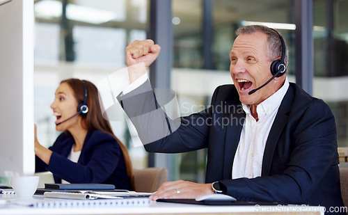 Image of Winner, motivation and a senior man in a call center for success in customer service or support. Wow, deal or sale with a happy mature male consultant in celebration at his crm office desk at work