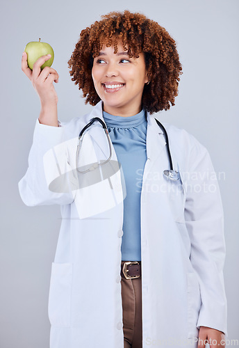 Image of Doctor, woman and smile with apple in white background, studio and vitamin c wellness. Happy female medical worker, nutritionist and advice of green fruits for nutrition, healthy food and detox diet