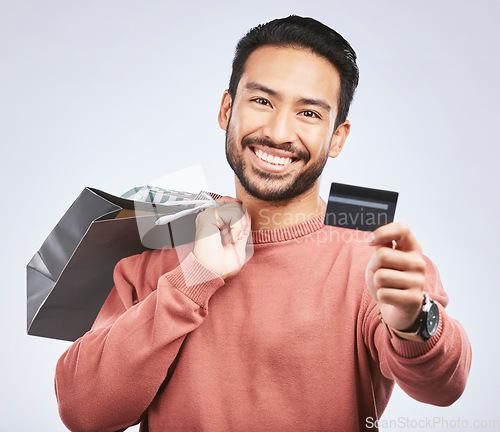 Image of Shopping bag, portrait or man with smile, debit card and happiness for retail fashion spree, sales discount or boutique deal. Promotion face, studio credit payment or happy person on white background