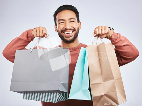 Image of Shopping bag, studio portrait and happy man customer or client with retail product, gift or fashion spree choice. Boutique discount deal, market present and excited person smile on white background