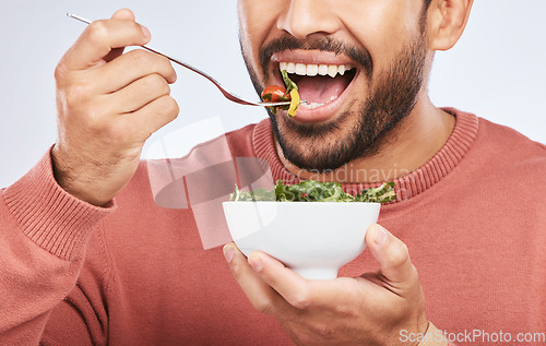 Image of Health studio, man and mouth eating salad, vegetables or green food product for weight loss, healthy lifestyle or nutrition. Closeup nutritionist, lettuce bowl and hungry person on white background