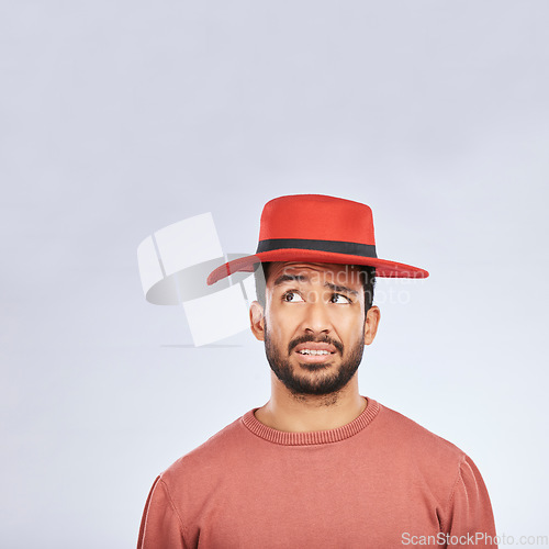 Image of Fashion, hat and mockup with a confused man in studio isolated on a gray background in doubt about his style. Question, mistake and frown with a young asian male model in trendy red headwear