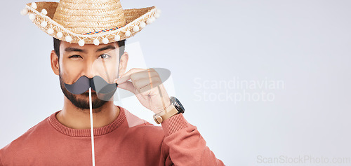 Image of Photo booth mockup, sombrero and portrait of man with mustache for comic, humor and funny joke. Costume, Mexican party accessory and silly face of male person on gray background with hat for comedy