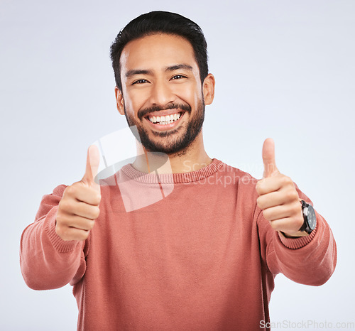 Image of Thumbs up, portrait and man support for success in studio, white background and winning news. Happy asian male model, thumb emoji and like of feedback, good review and vote yes in agreement of winner