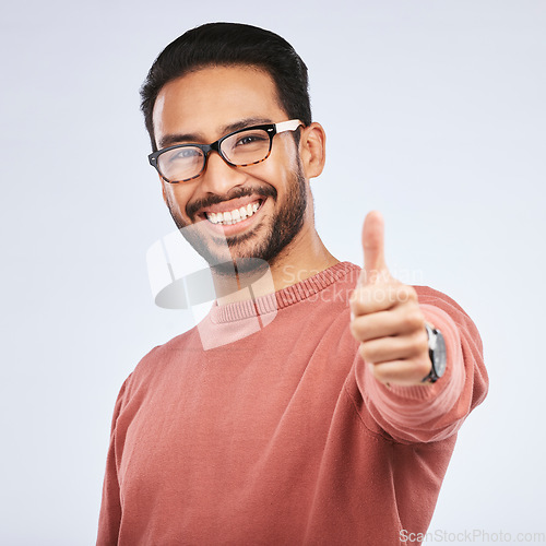 Image of Thumbs up, portrait and asian man with hands for success in studio, white background and winning news. Happy male model with glasses, ok emoji and like feedback, good review and vote yes in agreement