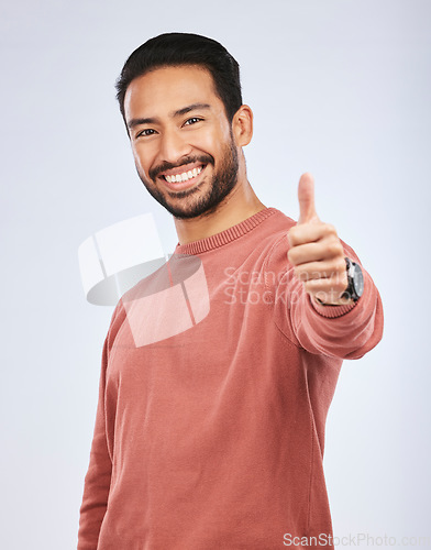 Image of Thumbs up, portrait and man vote for success in studio, white background and thank you. Happy asian male model, thumb emoji and support of winning, like and motivation of feedback, good review or yes