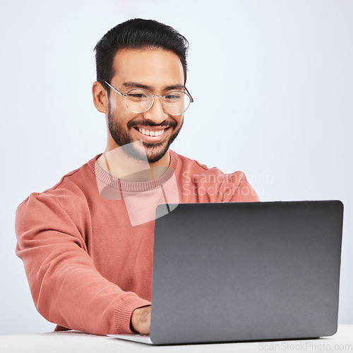 Image of Laptop, IT and man with glasses in studio, white background and programming digital code. Happy asian male model, software developer and computer engineer typing on technology for coding website data