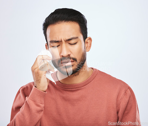 Image of Depression, crying and sad asian man in studio with tissue, criss or broken heart on grey background. Stress, mistake and face of male person with tears for anxiety, trauma or crisis, regret or fail