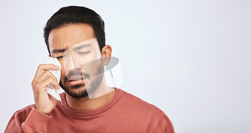 Image of Crying, depression and sad asian man in studio with tissue, crisis or broken heart on grey background. Stress, mistake and face of male with tears for anxiety, trauma or bad news, fail or mourning