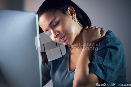 Image of Business woman, neck pain and night in stress, burnout or fatigue by computer at office. Frustrated, overworked and tired female person with sore shoulder, muscle or tension working late at workplace