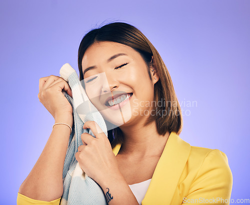 Image of Woman, soft jersey and smile in studio with fashion choice, quality fabric and happy by purple background. Young Japanese designer, material and excited with product, touch skin and pride in career