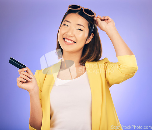 Image of Credit card, sunglasses portrait and woman shopping, retail banking and finance, e commerce or paperless payment. Happy customer, model or asian person with fashion loan on studio, purple background