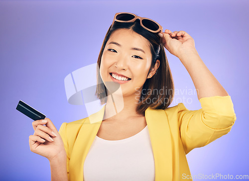 Image of Credit card, shopping portrait and woman in sunglasses, retail banking and finance, e commerce or payment. Happy customer, fashion model or asian person for debit pay on studio purple background