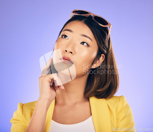 Image of Thinking, glasses and wondering with asian girl or idea in purple background in studio with decision. Choice, contemplation and woman with creative thought or face and person or option for solution.