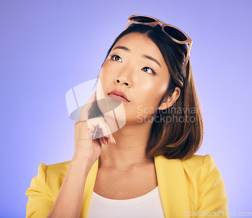 Image of Decision, idea and asian woman with wonder or choice with purple background in studio with glasses. Contemplating, girl and vision or thoughtful face with doubt for option or solution on mind.