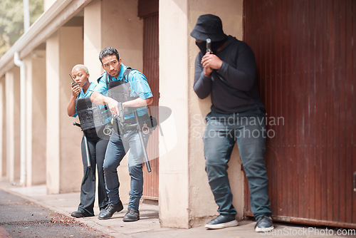 Image of Police, crime and gun with criminal in outdoor for security with law enforcement at house. Security, man and robber with weapon with investigation on duty together in driveway for justice with cop.