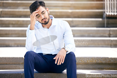 Image of Business man, stress and outdoor on stairs with a headache, depression or burnout in city. Young Indian male entrepreneur frustrated, anxiety or problem after being fired, unemployed or fail mistake