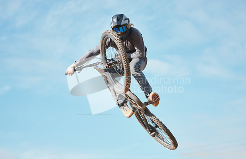 Image of Extreme sports, bike jump and cyclist cycling a bicycle for competition stunt routine or training speed in mockup space. Skill, contest and athlete workout or practice sky or air trick for fitness