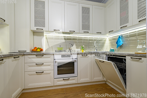 Image of White kitchen in classic style, oven door is open