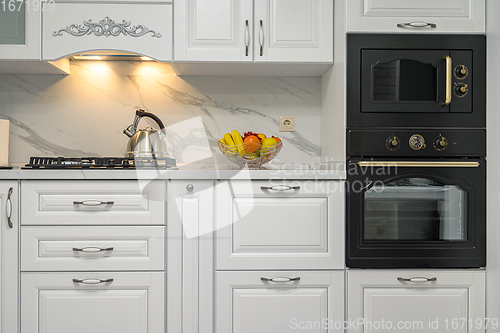 Image of White kitchen in classic style, front view