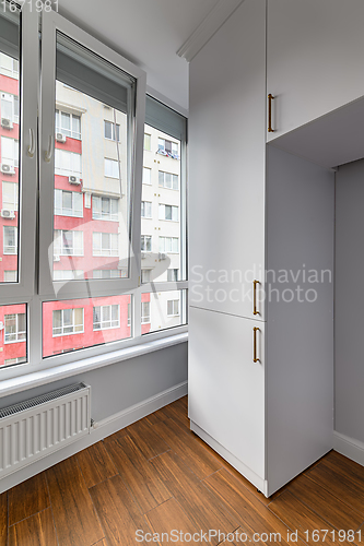 Image of Empty heated penthouse living room with floor to ceiling windows