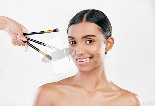 Image of Portrait, skincare and woman with makeup, brushes and dermatology against a white studio background. Face, female person or model with cosmetics tools, shine or luxury with wellness, facial or health