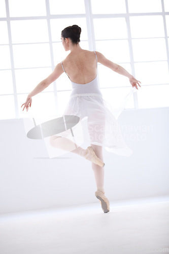 Image of Dance, ballet and training with woman in studio for balance, elegant and performance. Artist, theatre and creative with female ballerina dancing in class for competition, freedom and commitment