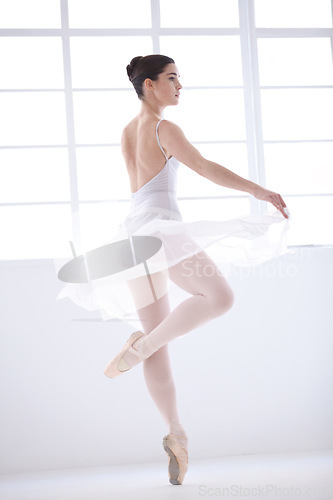 Image of Dance, ballet and beauty with woman in studio for balance, elegant and performance. Artist, theatre and training with female ballerina dancing in class for competition, freedom and commitment