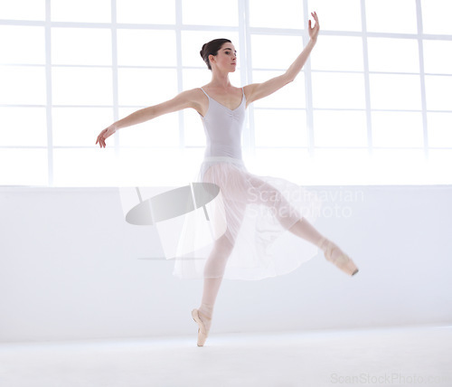 Image of Performance, ballet and creative with woman in studio for balance, elegant and dance. Artist, theatre and training with female ballerina dancing in class for competition, freedom and commitment