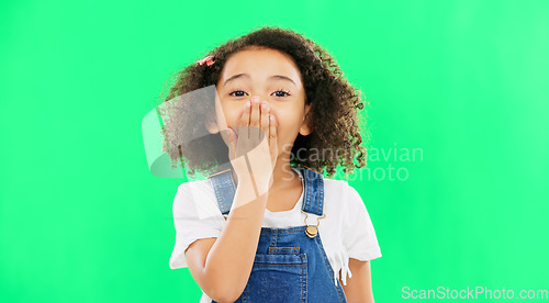 Image of Wow, surprise and children with a girl on a green screen background standing hand over mouth. Portrait, face and gasp with an adorable little female child hearing gossip or a rumor on chromakey