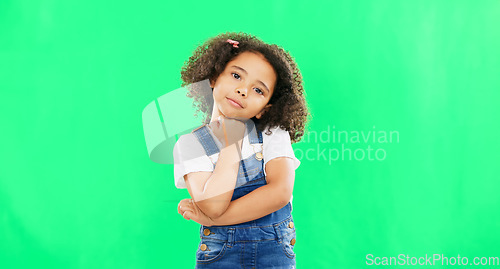 Image of Cute, face and child in a studio with green screen with a adorable, sweet and happy expression. Happiness, smile and portrait of a young girl kid posing while isolated by a chroma key background.